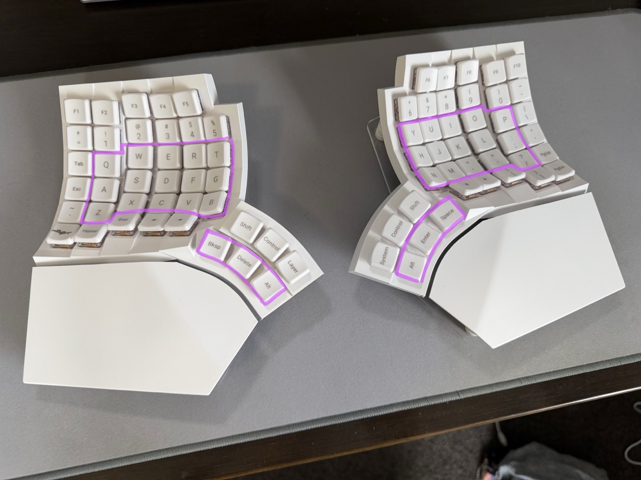 A Glove80 keyboard with the keys used by the Miryoku layout outlined in purple