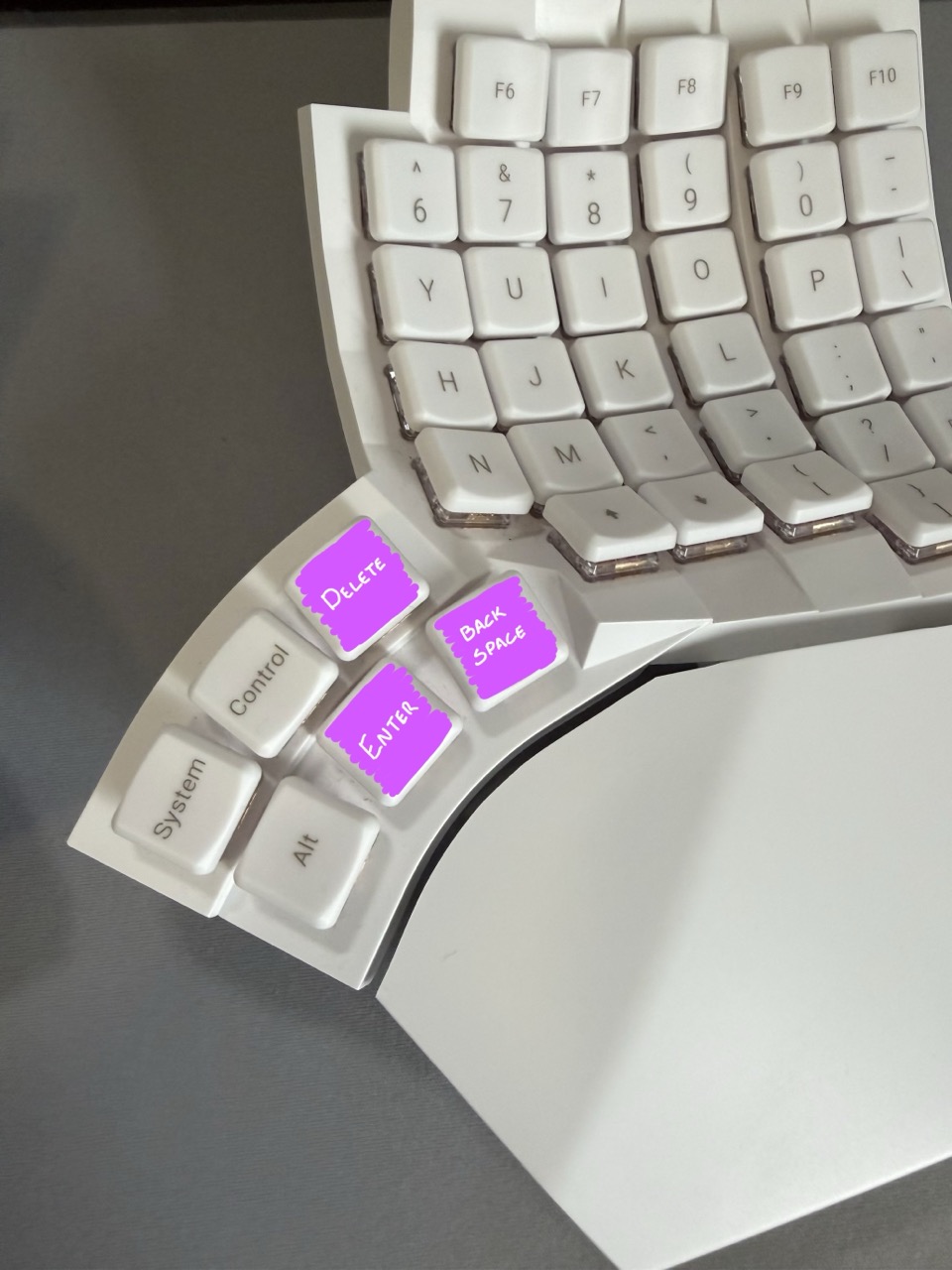 Modified thumb key layout on the Glove80, with Delete on the top row, Backspace beneath it and Enter to the left